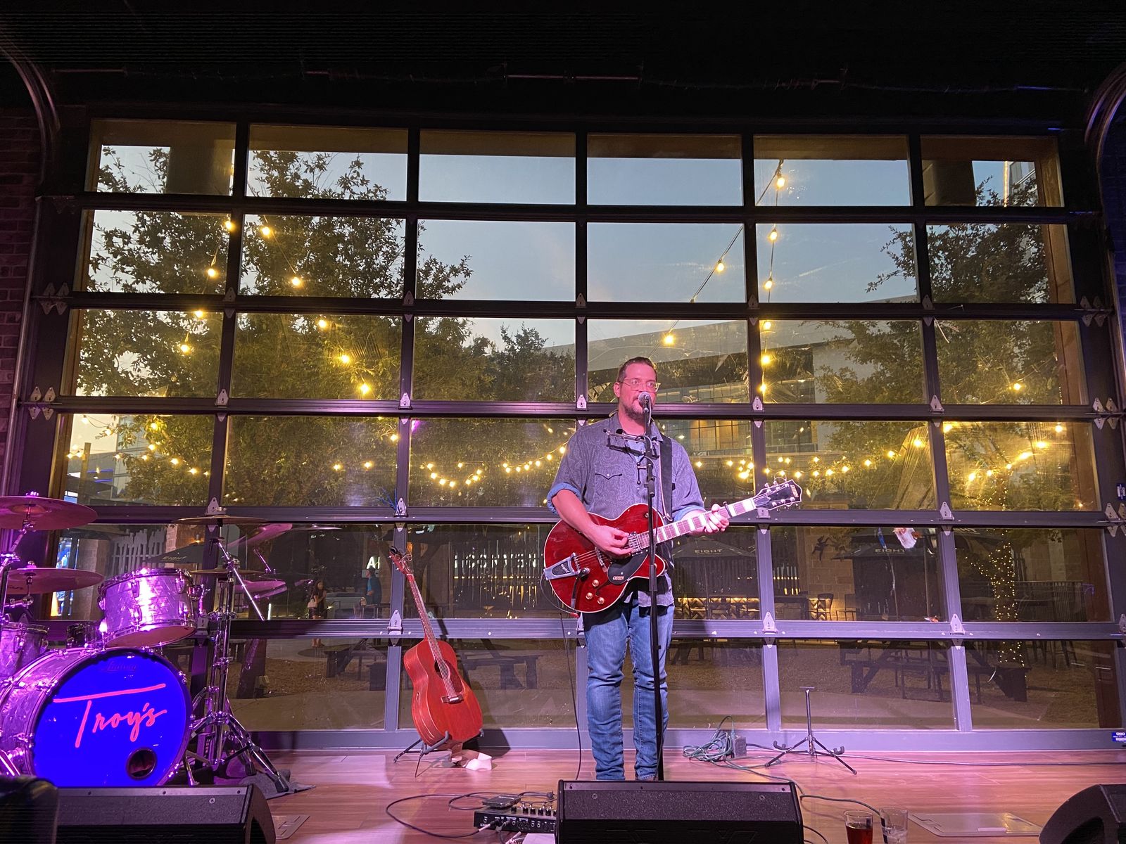 Wilhyme on stage at Troy's at Texas Live under string lights